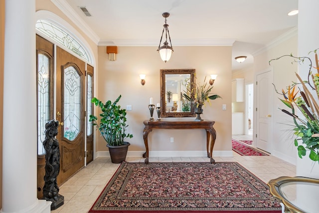 foyer entrance featuring crown molding, light tile patterned floors, baseboards, and visible vents