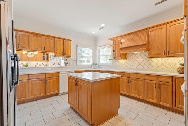 kitchen featuring crown molding, visible vents, stainless steel refrigerator with ice dispenser, light countertops, and white dishwasher