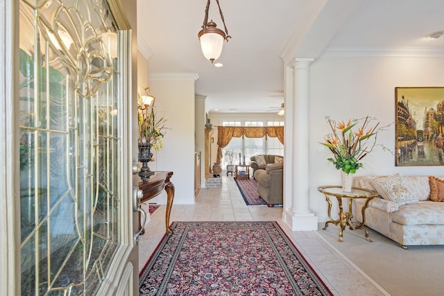 entryway featuring ornamental molding, ornate columns, light tile patterned floors, and a ceiling fan