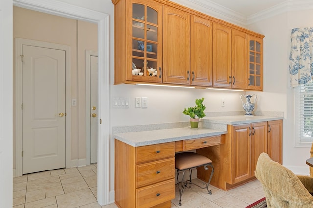 interior space with built in desk, crown molding, and light tile patterned floors