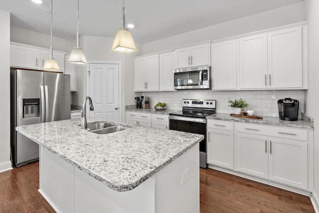 kitchen with stainless steel appliances, white cabinetry, and a sink
