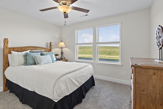bedroom featuring ceiling fan, light colored carpet, baseboards, and visible vents