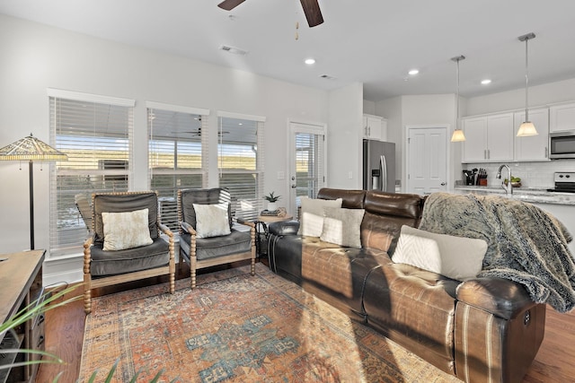 living room with visible vents, recessed lighting, a ceiling fan, and wood finished floors