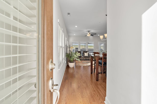 foyer featuring wood finished floors, a ceiling fan, visible vents, and recessed lighting