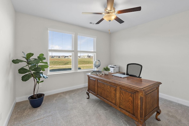 office area featuring visible vents, ceiling fan, light carpet, and baseboards