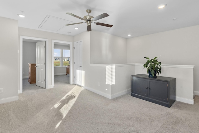 carpeted empty room featuring attic access, baseboards, a ceiling fan, and recessed lighting