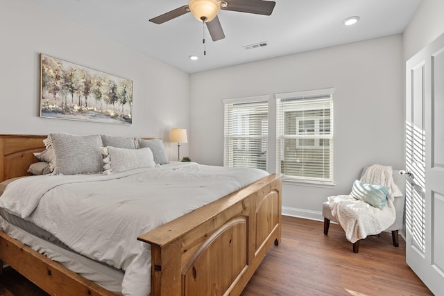 bedroom featuring visible vents, baseboards, a ceiling fan, recessed lighting, and wood finished floors
