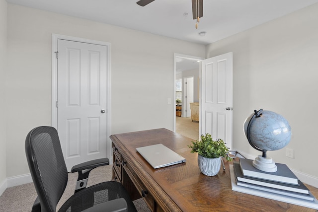 office area with baseboards and ceiling fan