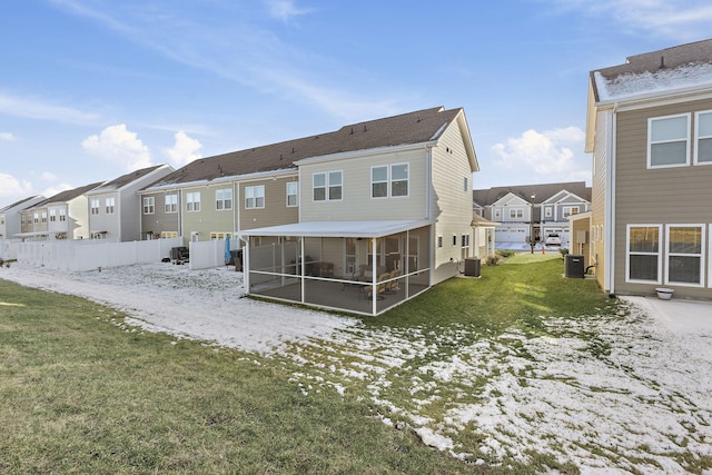 back of property featuring a residential view, a yard, cooling unit, and a sunroom