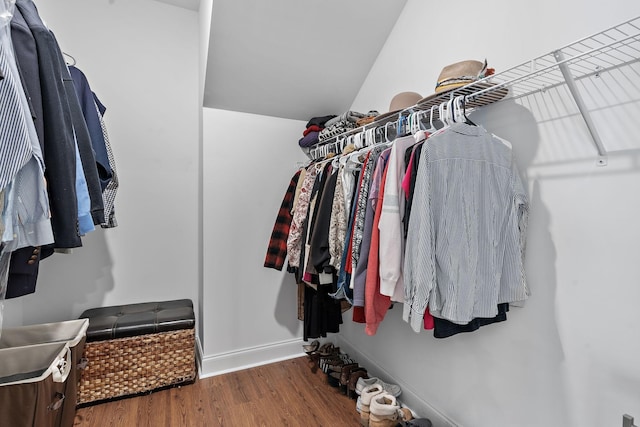 walk in closet with wood finished floors
