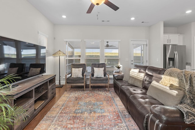 living area featuring dark wood-style floors, a ceiling fan, visible vents, and recessed lighting