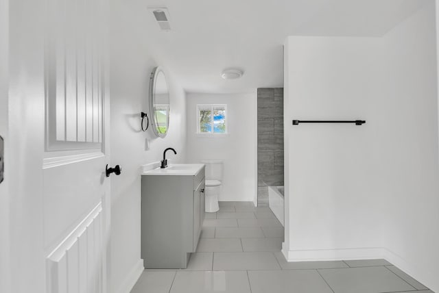 full bathroom with vanity, baseboards, tile patterned floors, shower / tub combination, and toilet