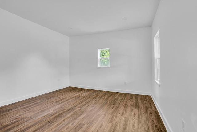 unfurnished room featuring baseboards and wood finished floors