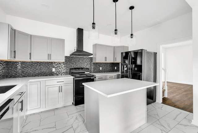 kitchen with gray cabinets, wall chimney exhaust hood, decorative backsplash, marble finish floor, and black appliances