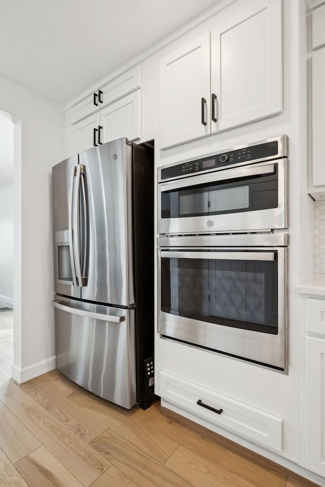 1048 Edgewater Cir, Gallatin, TN 37066 - kitchen featuring appliances with stainless steel finishes, white cabinetry, and light wood-type flooring