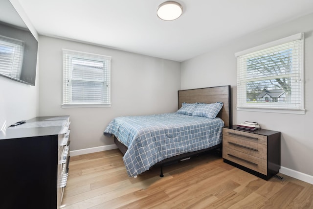 1048 Edgewater Cir, Gallatin, TN 37066 - bedroom with multiple windows, baseboards, and light wood-type flooring