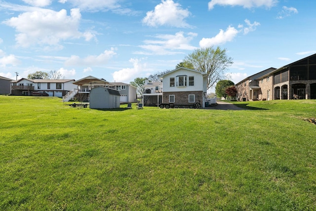 1048 Edgewater Cir, Gallatin, TN 37066 - view of yard featuring a storage unit, a residential view, and an outdoor structure