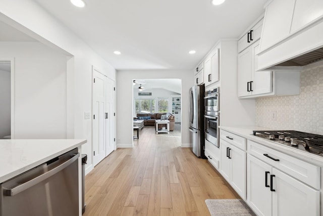 1048 Edgewater Cir, Gallatin, TN 37066 - kitchen featuring tasteful backsplash, stainless steel appliances, light countertops, ceiling fan, and premium range hood