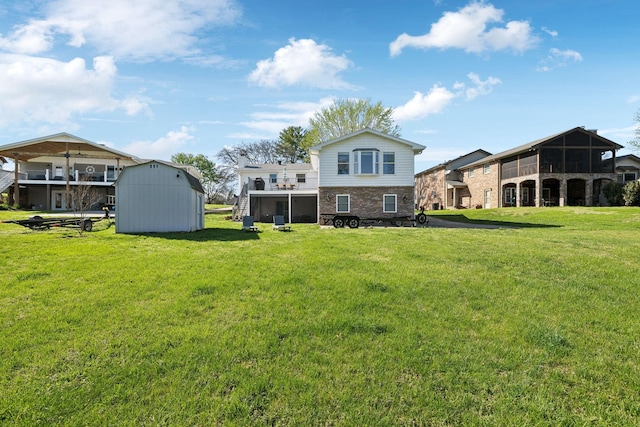 1048 Edgewater Cir, Gallatin, TN 37066 - back of house featuring a lawn, brick siding, and an outbuilding