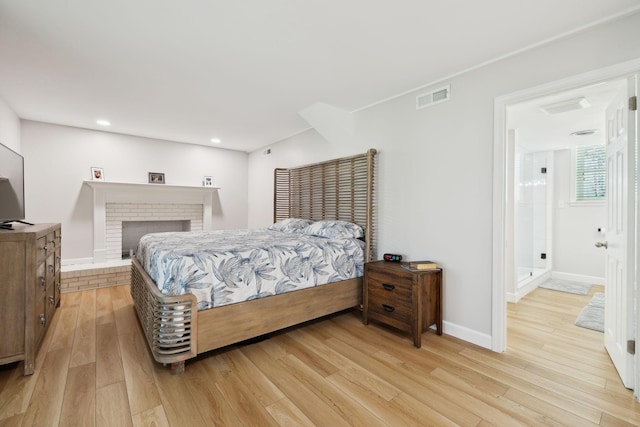 1048 Edgewater Cir, Gallatin, TN 37066 - bedroom with light wood-style flooring, visible vents, baseboards, recessed lighting, and a brick fireplace
