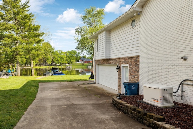1048 Edgewater Cir, Gallatin, TN 37066 - view of side of home featuring driveway, a water view, an attached garage, a lawn, and brick siding