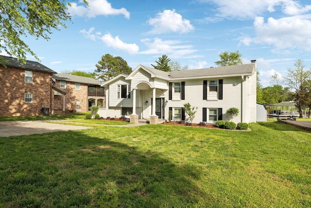 1048 Edgewater Cir, Gallatin, TN 37066 - raised ranch with a chimney, a front yard, and brick siding