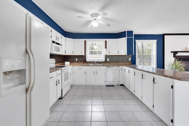 kitchen with plenty of natural light, white appliances, a sink, and ceiling fan