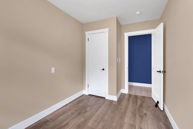 unfurnished bedroom with baseboards and wood finished floors