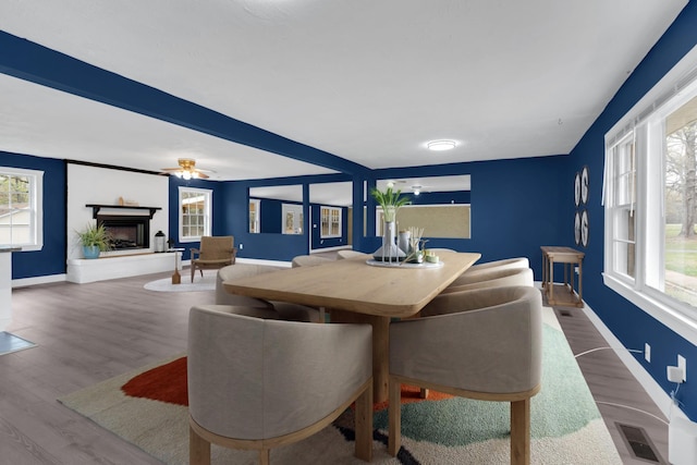 dining space featuring wood finished floors, visible vents, and a wealth of natural light