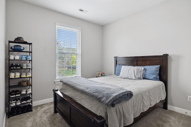 bedroom featuring baseboards, visible vents, and carpet floors