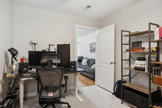 office with baseboards and visible vents