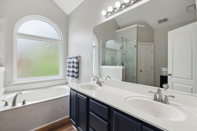 full bath with visible vents, a sink, and lofted ceiling