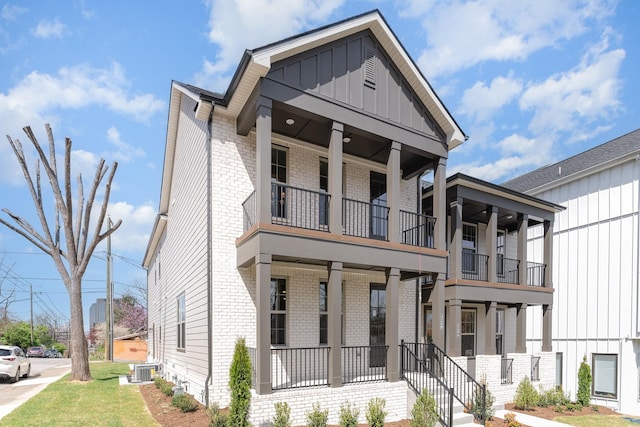 3106B Wellington Ave, Nashville, TN 37212 - view of front of property featuring board and batten siding, a balcony, a front yard, central AC unit, and brick siding