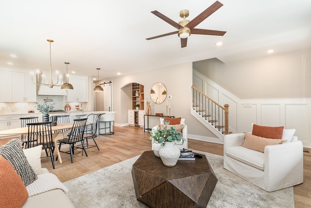 3106B Wellington Ave, Nashville, TN 37212 - living area featuring stairs, arched walkways, recessed lighting, light wood finished floors, and ceiling fan with notable chandelier