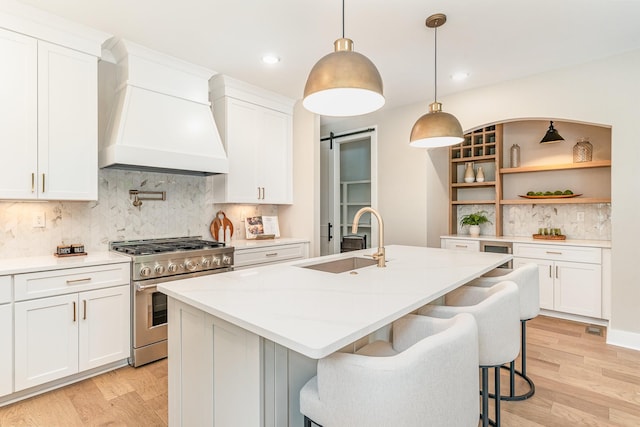 3106B Wellington Ave, Nashville, TN 37212 - kitchen with high end stainless steel range oven, custom exhaust hood, light wood finished floors, and a sink