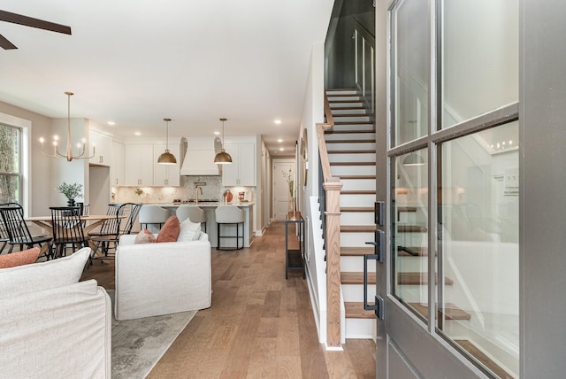 3106B Wellington Ave, Nashville, TN 37212 - living room with recessed lighting, ceiling fan with notable chandelier, stairway, and light wood-type flooring