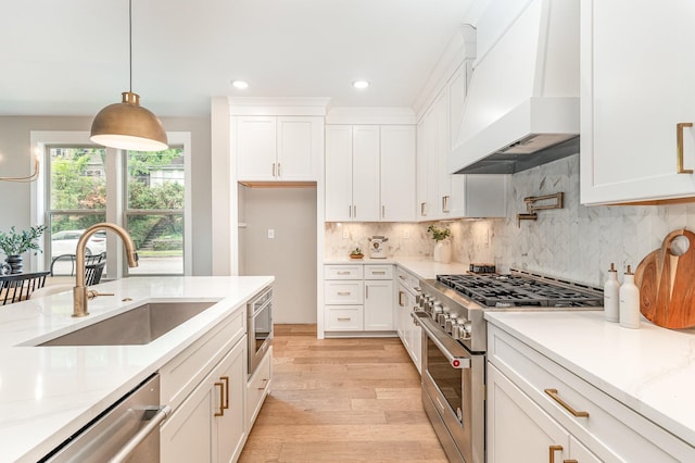 3106B Wellington Ave, Nashville, TN 37212 - kitchen with a sink, light wood-style floors, custom exhaust hood, white cabinetry, and appliances with stainless steel finishes