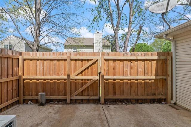 view of gate featuring a patio area and fence