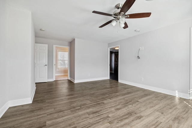 empty room with baseboards, a ceiling fan, and wood finished floors