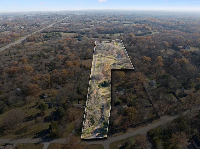 birds eye view of property featuring a view of trees