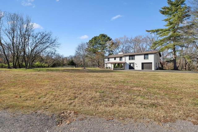 view of yard with driveway and a garage