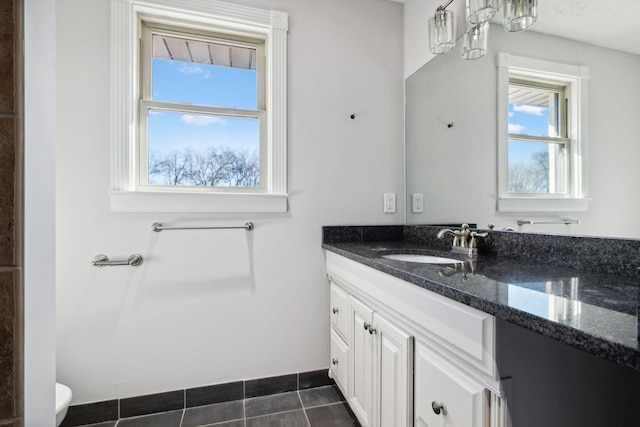bathroom featuring toilet, tile patterned floors, and vanity