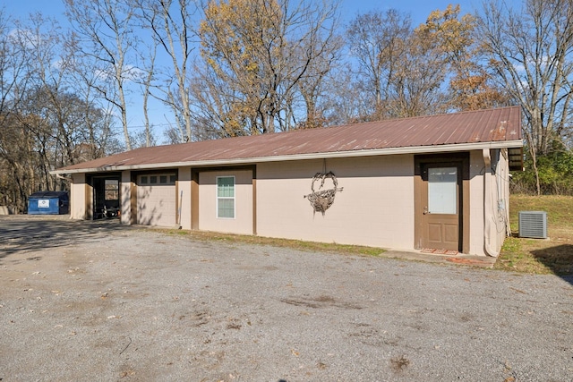exterior space featuring driveway, an outdoor structure, and an attached garage