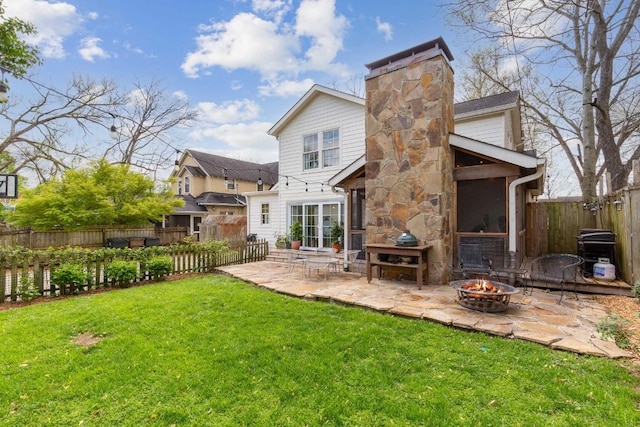 210 Cherokee Rd, Nashville, TN 37205 - rear view of house with a patio area, an outdoor fire pit, a lawn, a chimney, and a fenced backyard