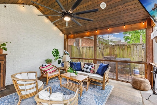 210 Cherokee Rd, Nashville, TN 37205 - sunroom / solarium with brick wall, wood finished floors, an outdoor living space with a fireplace, and a ceiling fan
