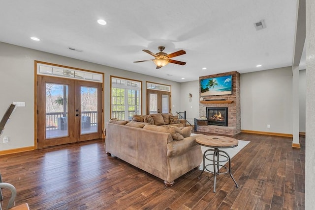 700 Falls Rd, Monterey, TN 38574 - living area with visible vents, baseboards, a brick fireplace, dark wood finished floors, and french doors