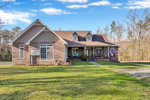 700 Falls Rd, Monterey, TN 38574 - view of front facade featuring covered porch, a front yard, and brick siding