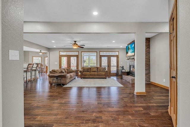 700 Falls Rd, Monterey, TN 38574 - living area with baseboards, ceiling fan, wood finished floors, a large fireplace, and french doors