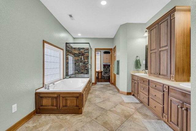 700 Falls Rd, Monterey, TN 38574 - full bath featuring a garden tub, visible vents, a sink, double vanity, and baseboards