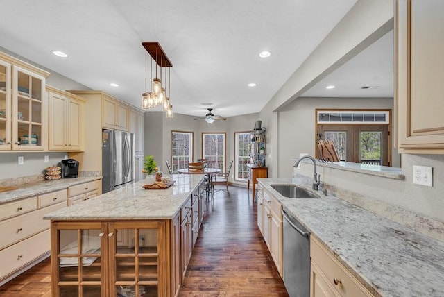 700 Falls Rd, Monterey, TN 38574 - kitchen featuring stainless steel appliances, a sink, cream cabinetry, and a healthy amount of sunlight